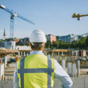 Construction worker overseeing a building site, representing commercial expansion and business growth financing.