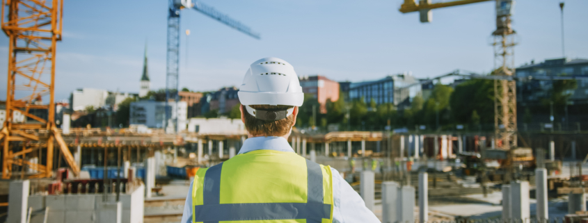 Construction worker overseeing a building site, representing commercial expansion and business growth financing.