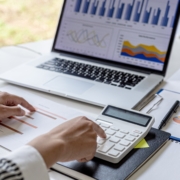 Hands at a keyboard. A small business owner wonders How much working capital does your small business need?