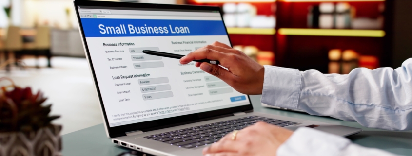 Laptop displaying small business financing options comparing working capital loans vs. line of credit.