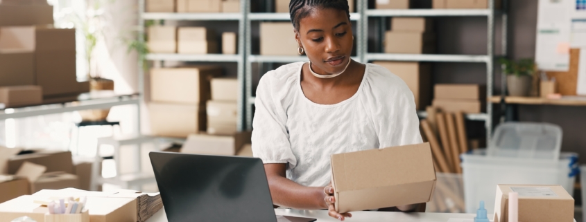 Black female entrepreneur evaluating financing options and loan-to-value ratio for small businesses at her desk.