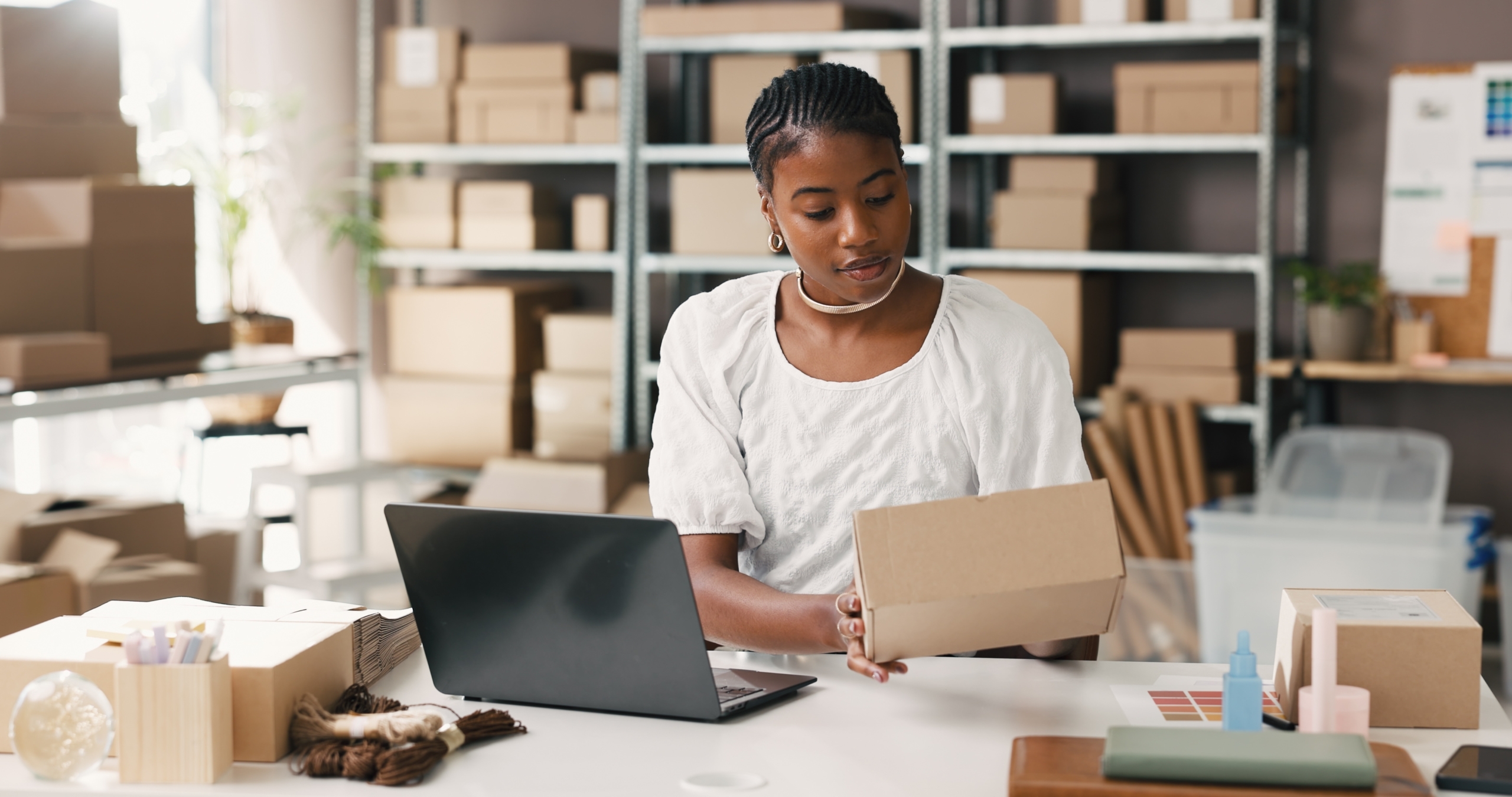 Black female entrepreneur evaluating financing options and loan-to-value ratio for small businesses at her desk.